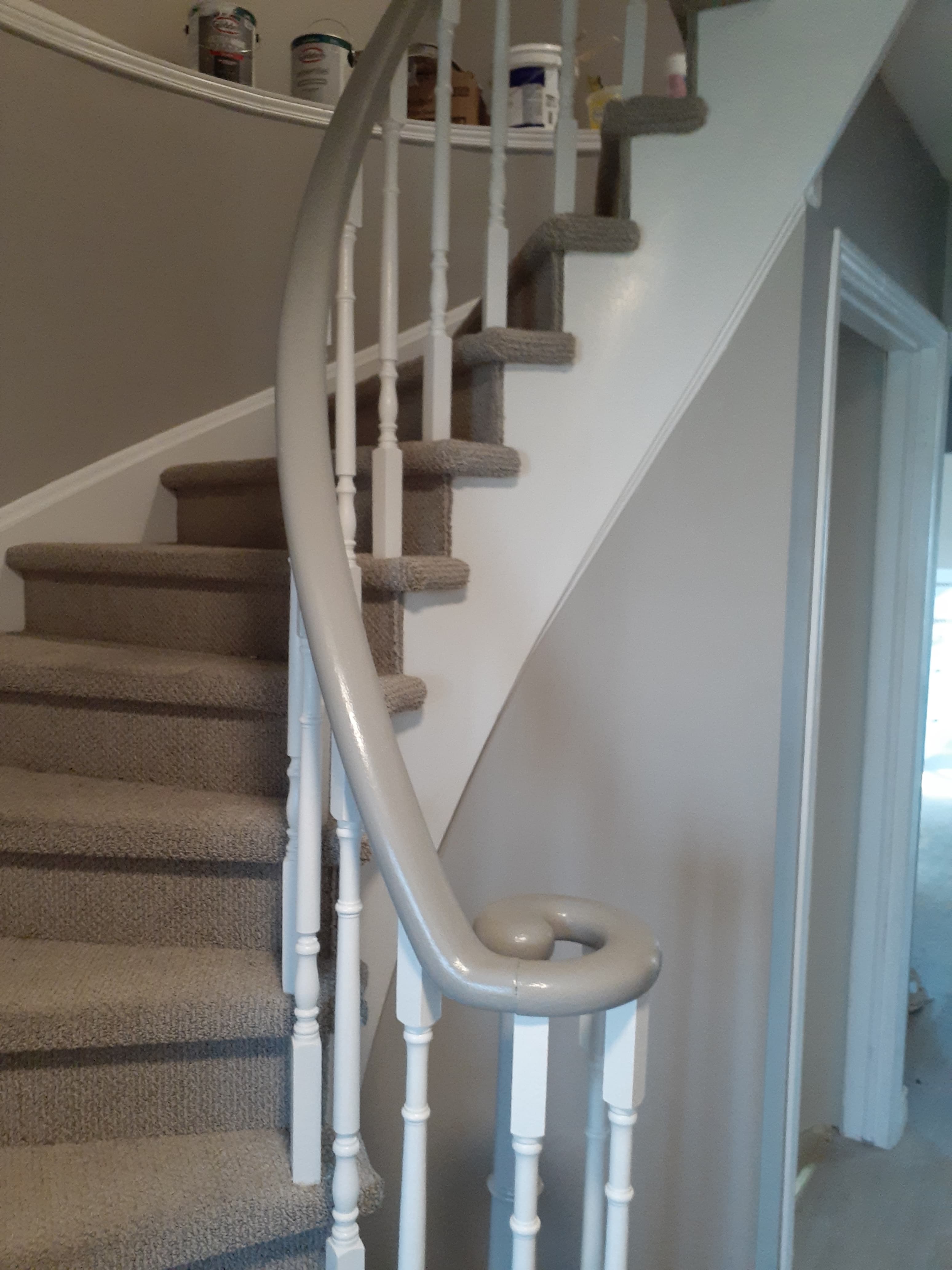 Same staircase after handrail and trim painted to a cohesive finish